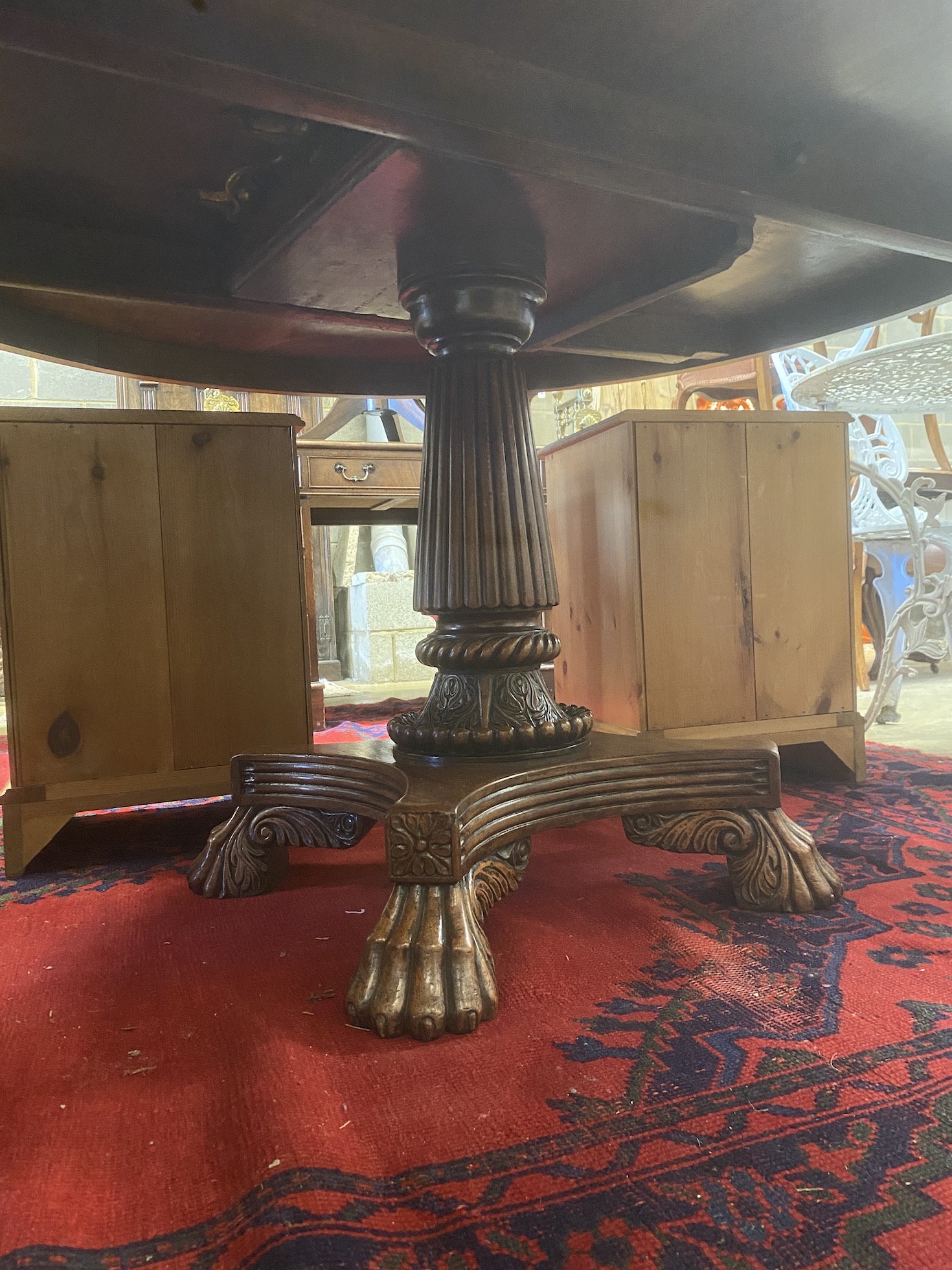A WIlliam IV circular mahogany tilt top breakfast table on fluted column and lion's paw feet, diameter 145cm, height 76cm